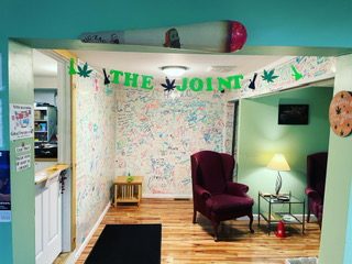 This is the Smoking Lounge from The Joint Premium Dispensary store. This angle shows the freedom wall where customers are able to leave messages on there.